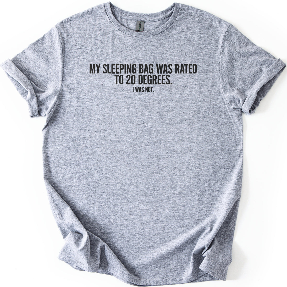 Rated To 20 Degrees Comfort Colors T-shirt in Sport Grey, laid flat. Black block capitals across the chest read My sleeping bag was rated to 20 degrees, with I was not in smaller letters below. The shirt has rolled sleeves and lies on a white background.