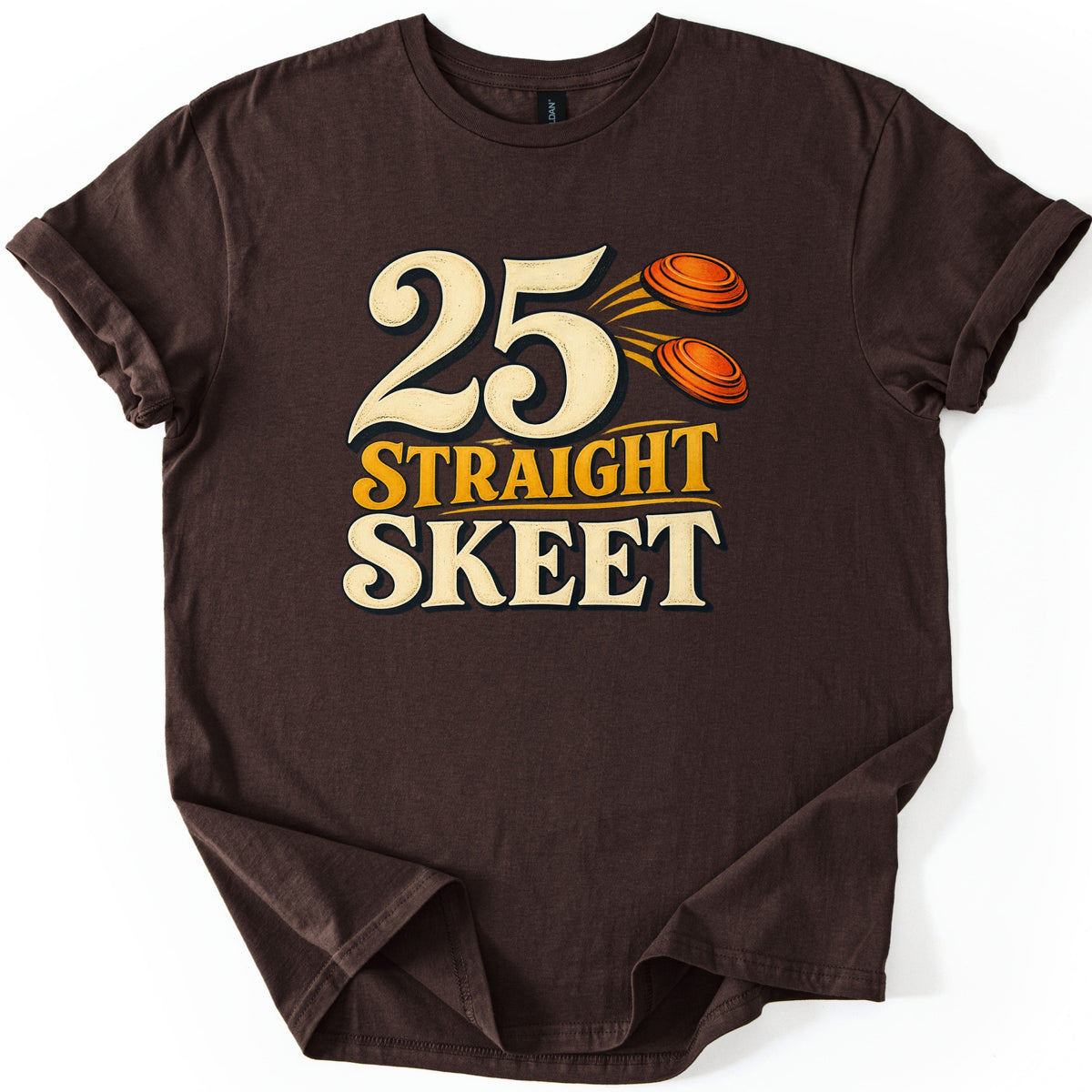 25 Straight Skeet Comfort Colors T-shirt in Dark Chocolate, laid flat. Large cream numbers 25 with two orange clay targets flying beside them, above the words Straight Skeet in gold and cream lettering. The shirt has rolled sleeves on a white background.