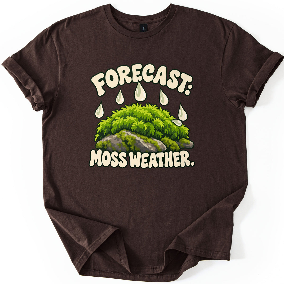 Forecast Moss Weather Comfort Colors T-shirt in Dark Chocolate, laid flat. Cream bubble letters read FORECAST: above white raindrops falling on a mound of bright green moss over gray rocks, with MOSS WEATHER. below. The shirt has rolled sleeves on a white background.