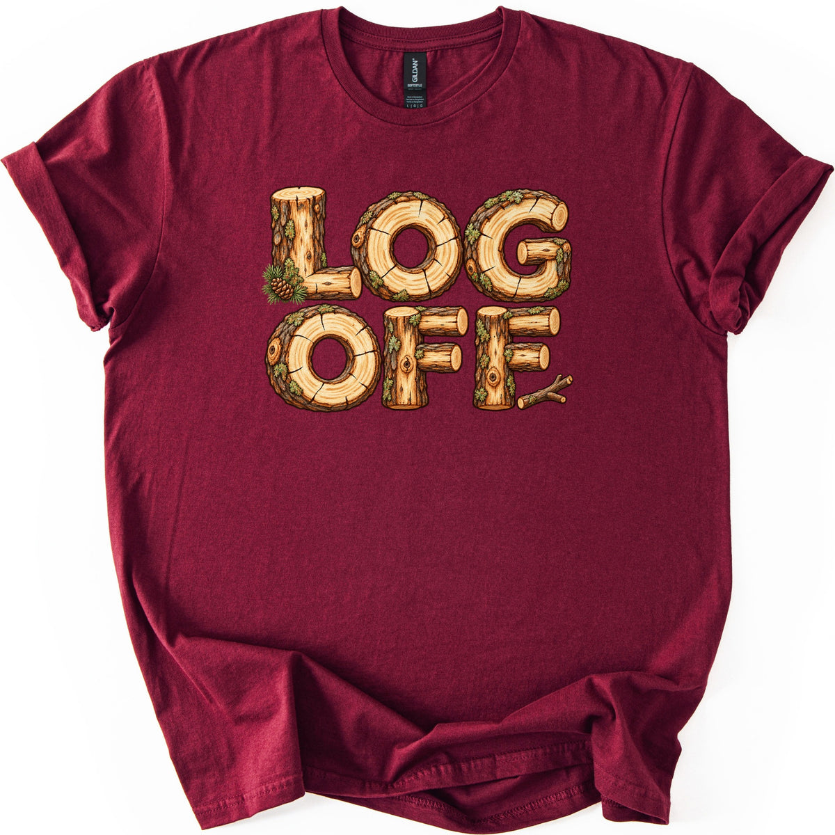 Log Off Comfort Colors T-shirt in Maroon, laid flat. The words LOG OFF are spelled in letters made of cut logs with bark, moss and tree rings, with a pine sprig and cone by the L and a twig after the last F. Sleeves are rolled on a white background.