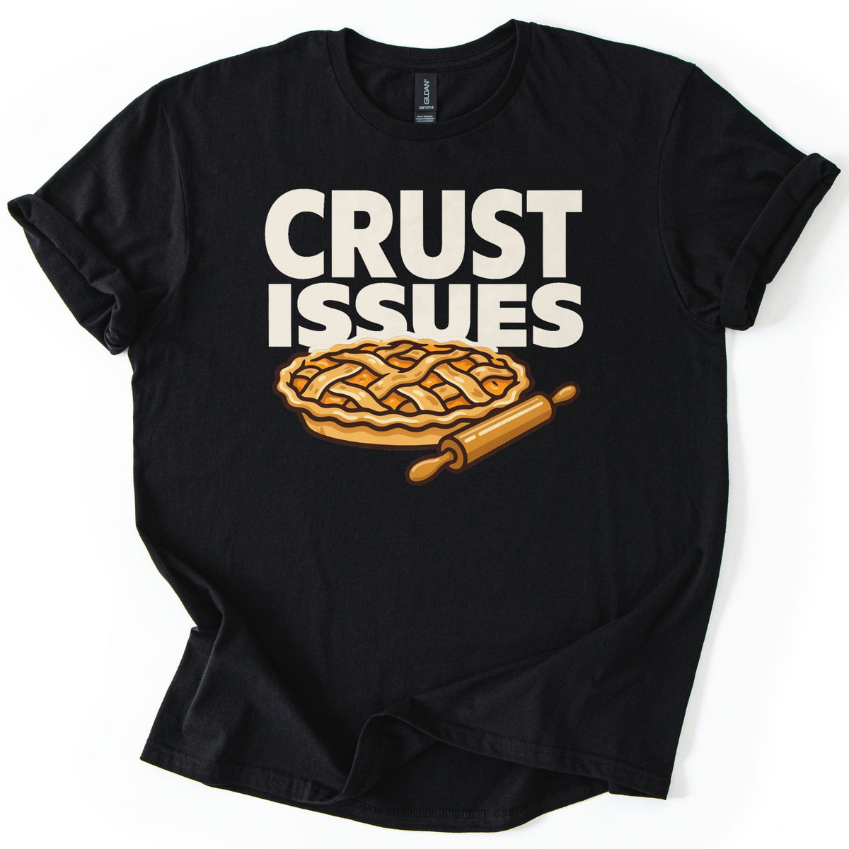 Crust Issues Comfort Colors T-shirt in Black, laid flat. Cream block letters read CRUST ISSUES above a cartoon lattice-top pie with a wooden rolling pin. The shirt has rolled sleeves and lies on a plain white background.