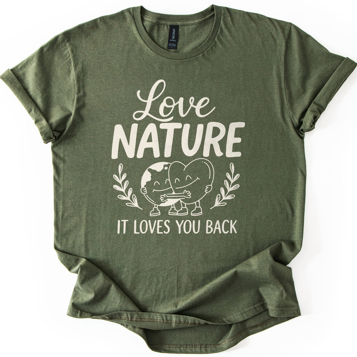 Nature Loves You Back Comfort Colors T-shirt in Military Green, laid flat. Cream print reads Love NATURE above a smiling cartoon Earth and heart hugging between two leafy sprigs, then IT LOVES YOU BACK. The sleeves are rolled and the shirt lies on a white background.