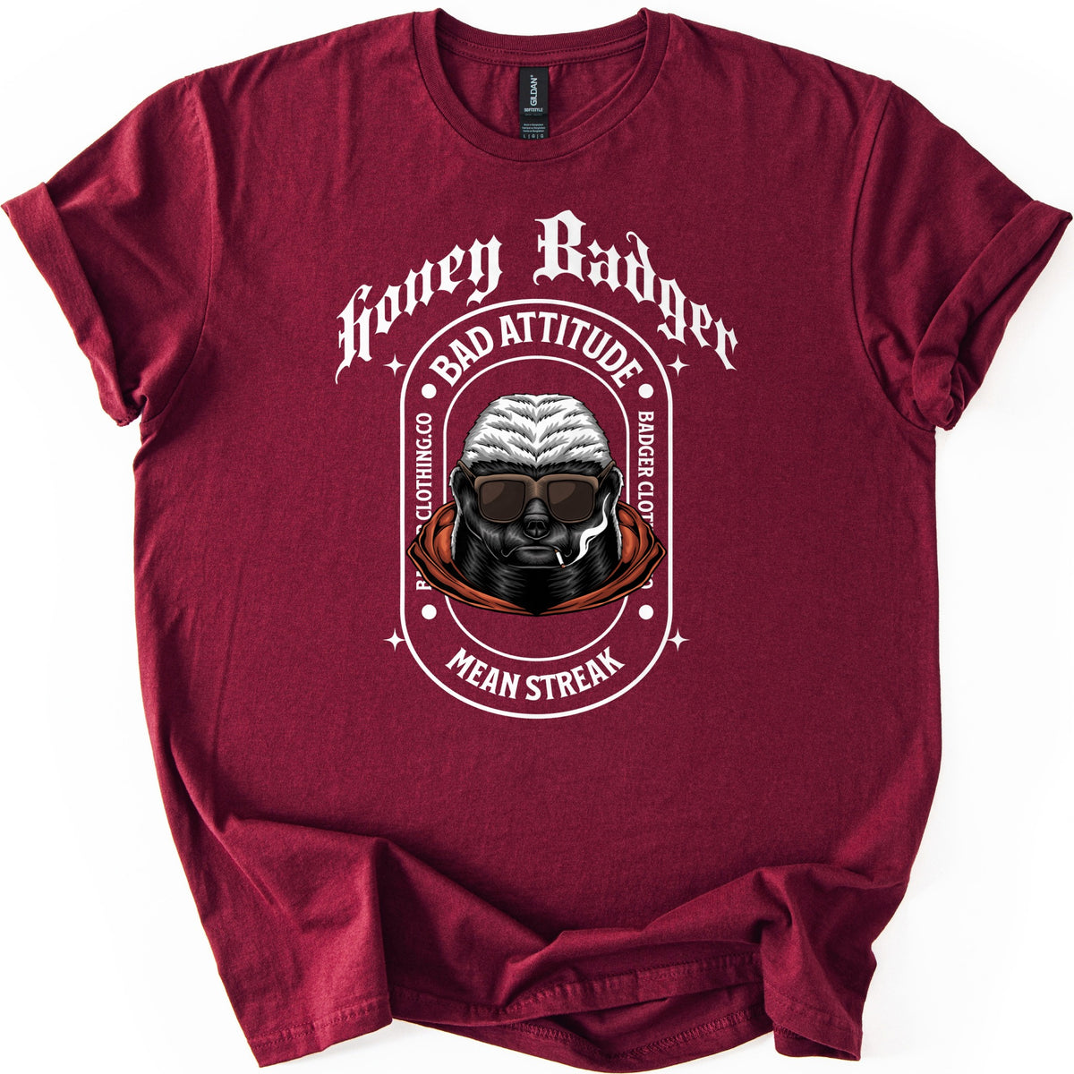 Bad Vibes Badger Comfort Colors T-shirt in Maroon, laid flat. White print: Honey Badger in gothic letters over an oval badge reading Bad Attitude, Badger Clothing.co and Mean Streak around a honey badger in sunglasses and an orange hood, smoking a cigarette. On a white background.