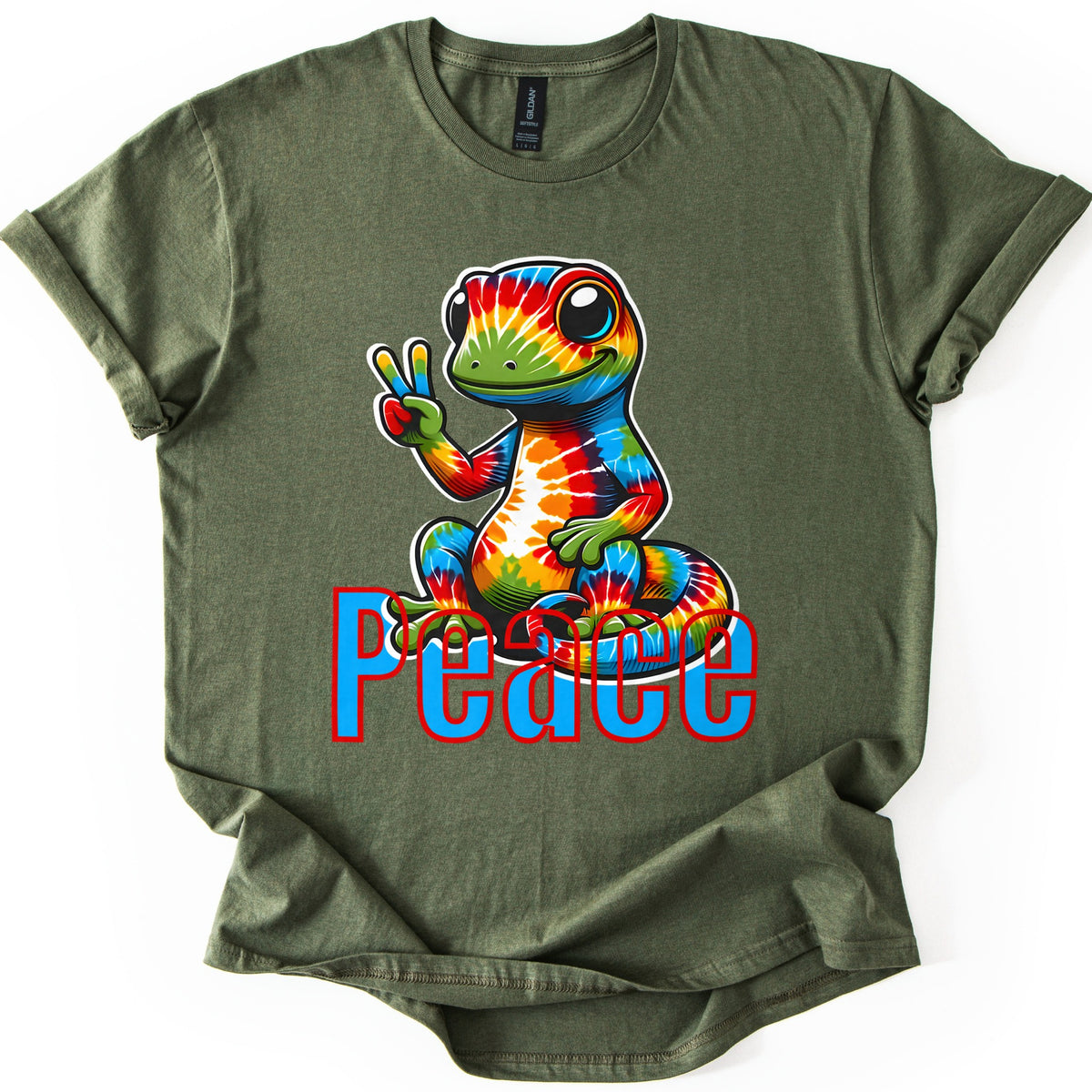 Rainbow Lizard Peace Comfort Colors T-shirt in Military Green, laid flat. A smiling cartoon lizard with tie-dye rainbow skin sits on its curled tail and flashes a peace sign above the word Peace in blue letters outlined in red. Cuffed sleeves on a white background.