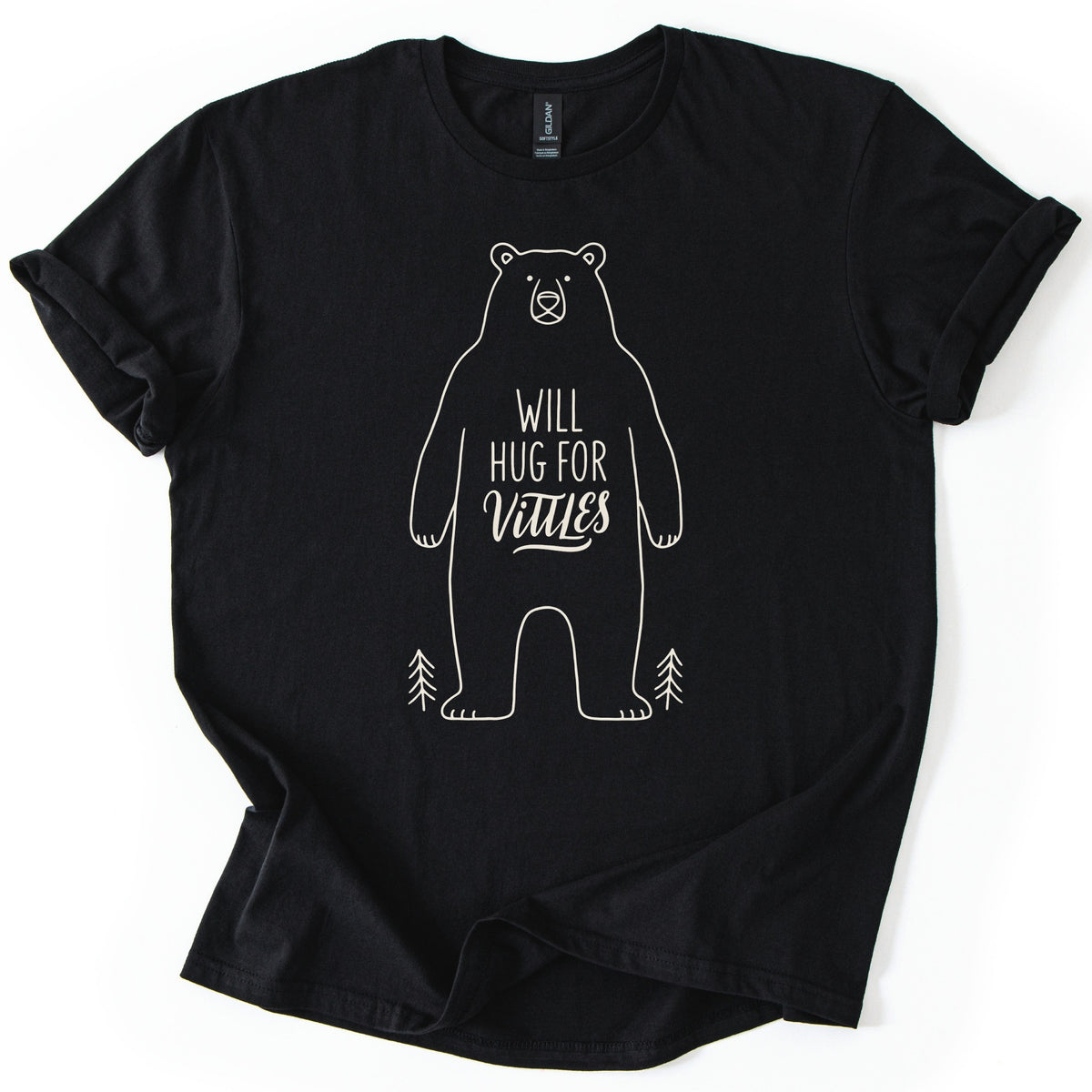 Will Hug For Vittles Bear Comfort Colors T-shirt in Black, laid flat. A cream line drawing of a standing bear with the words WILL HUG FOR Vittles on its belly and a small pine tree at each foot. The shirt has rolled sleeves and lies on a white background.