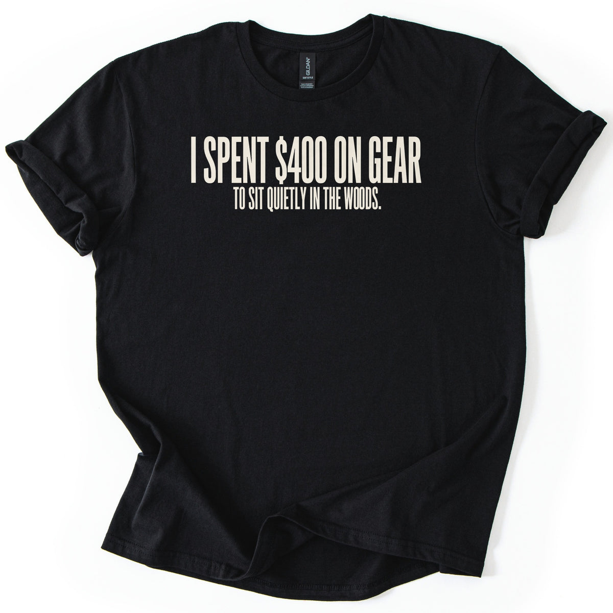 Gear To Sit Quietly Comfort Colors T-shirt in Black, laid flat. Off-white block letters across the chest read I SPENT $400 ON GEAR, with TO SIT QUIETLY IN THE WOODS. in smaller letters below. The shirt has rolled sleeves and lies on a white background.