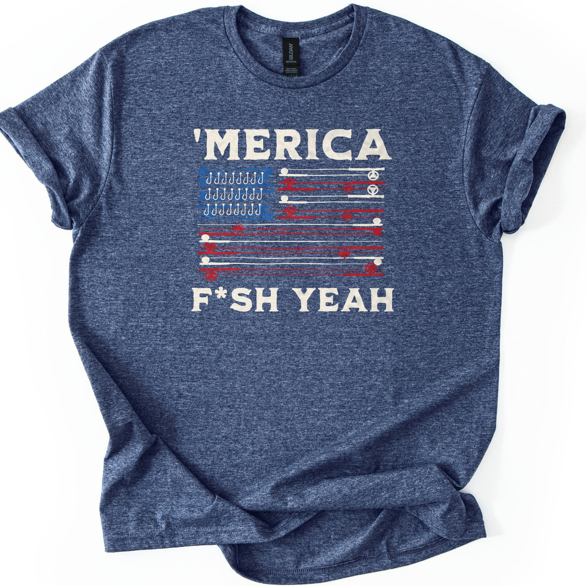 Fish America Fish Yeah Comfort Colors T-shirt in Heather Navy, laid flat. Cream letters spell 'MERICA over an American flag made of red and cream fishing rods with reels and a blue corner of hooks, with F*SH YEAH underneath. Cuffed sleeves on white.