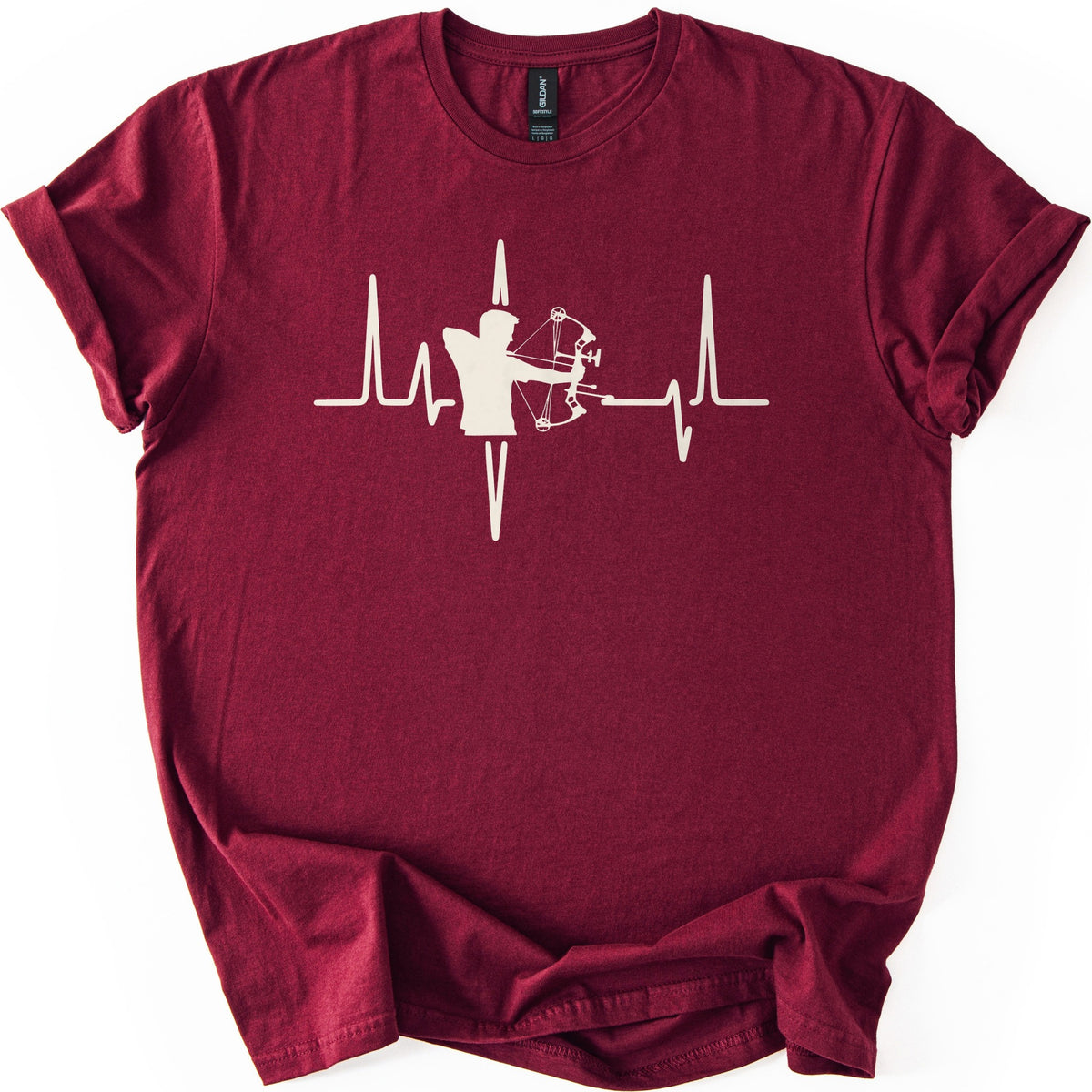 Compound Bow Archer Comfort Colors T-shirt in Maroon, laid flat. A cream silhouette of an archer drawing a compound bow sits in the middle of a heartbeat line across the chest, with no words. The shirt lies on a white background with its sleeves cuffed.
