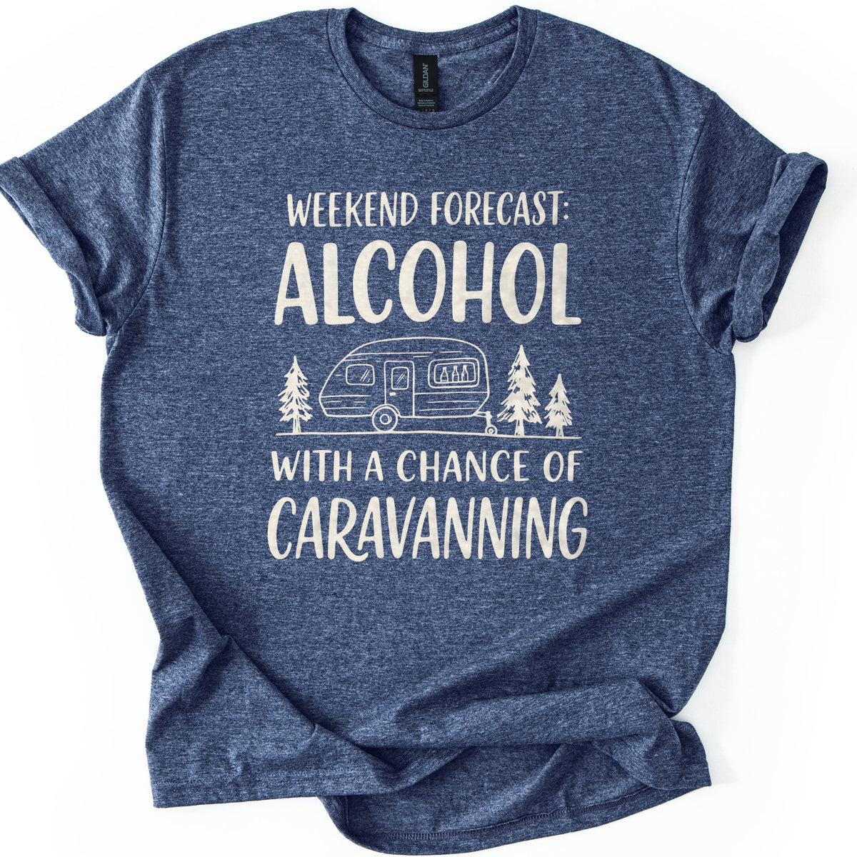 Weekend Forecast Caravanning Comfort Colors T-shirt in Heather Navy, laid flat. Cream print reads Weekend Forecast: Alcohol With a Chance of Caravanning around a line drawing of a caravan with bottles in its window between pine trees. Sleeves are cuffed on a white background.