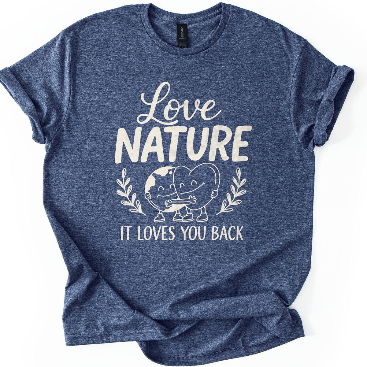 Nature Loves You Back Comfort Colors T-shirt in Heather Navy, laid flat. Cream print reads Love NATURE above a smiling cartoon Earth and heart hugging between two leafy sprigs, then IT LOVES YOU BACK. The sleeves are rolled and the shirt lies on a white background.