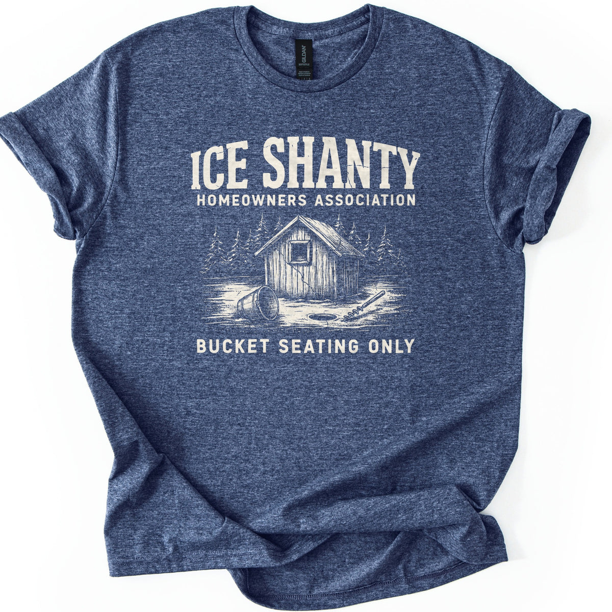 Ice Shanty Homeowners Association Comfort Colors T-shirt in Heather Navy, laid flat. Cream print reads ICE SHANTY, HOMEOWNERS ASSOCIATION above a sketch of a wooden ice shack among pines with a tipped bucket, ice hole and auger, then BUCKET SEATING ONLY. Sleeves cuffed, on white.